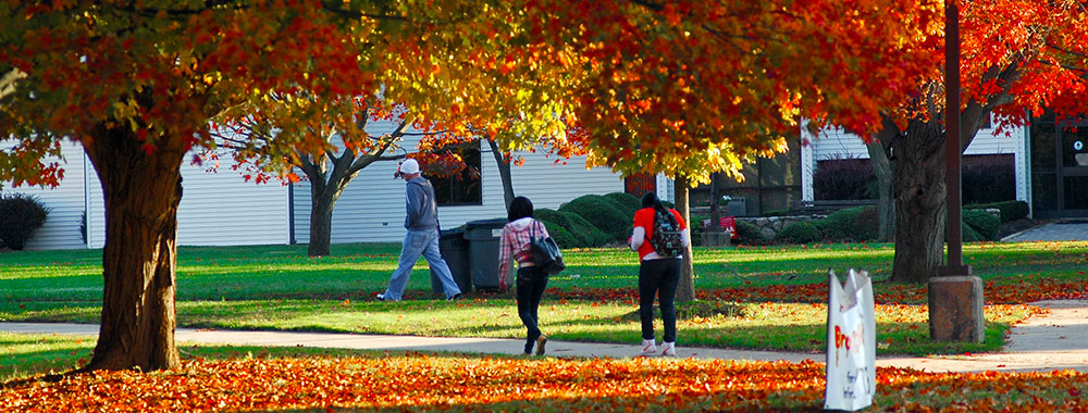 students walking across campus in the fall