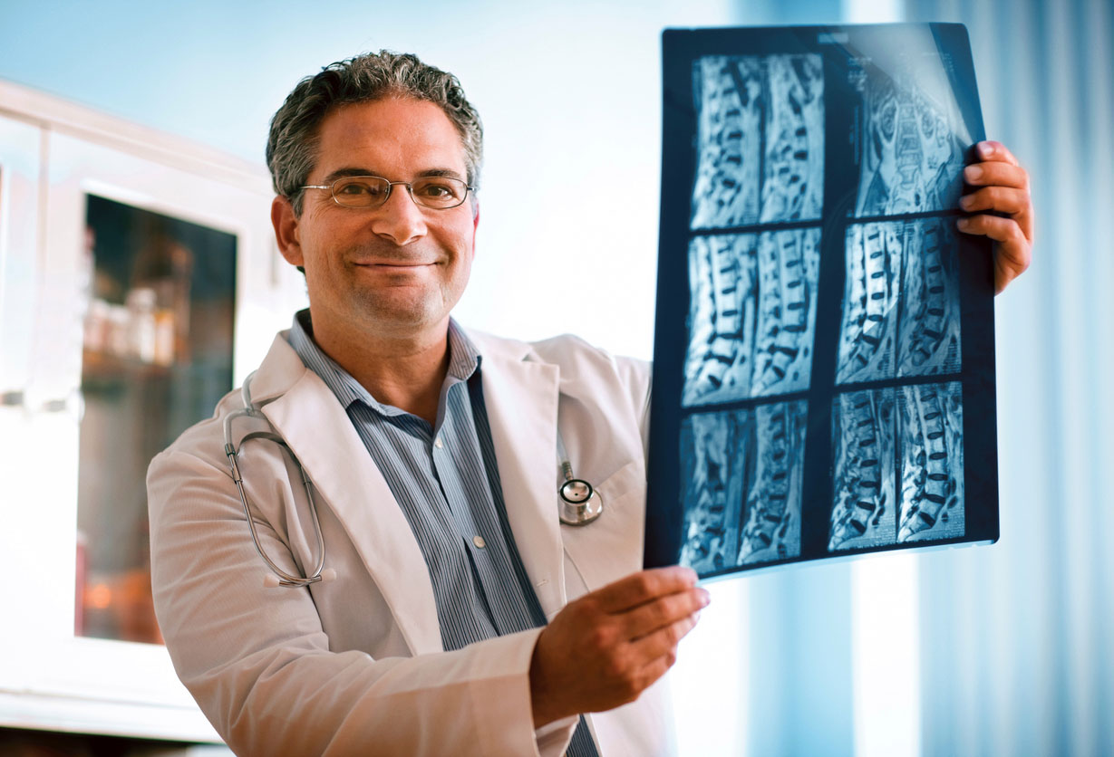 Doctor looking at MRI of spinal cord.