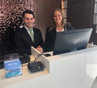 Man and Woman at a hotel front desk.