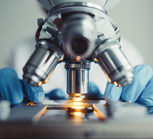 Close up of examining of test sample under the microscope