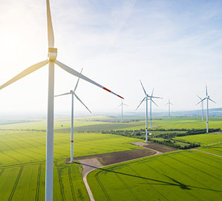 Aerial view of wind turbines and agriculture field