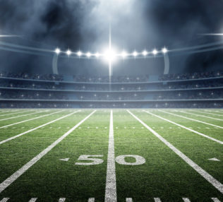 Picture of a football field in an arena.