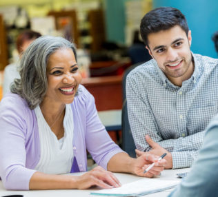 Woman talking to two students