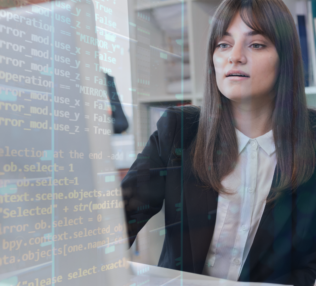 Woman at computer studying code