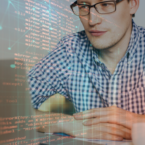 Man at computer studying code