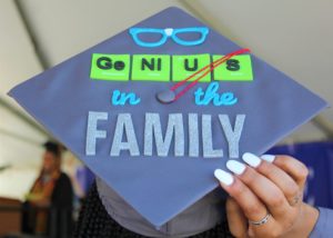 Decorated graduation cap that reads, "Genius in the family."
