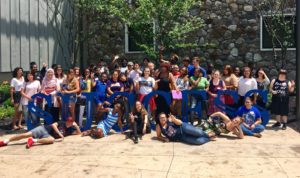 Large group of EOF student around the Success sculpture on campus