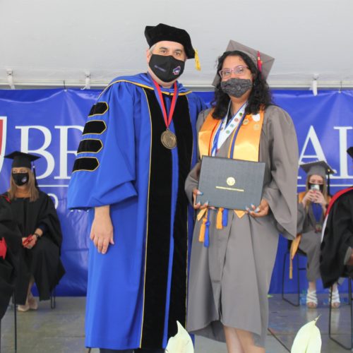 Cecilia Alcantar receives Outstanding Student Award from President Dr. David Stout at Graduation