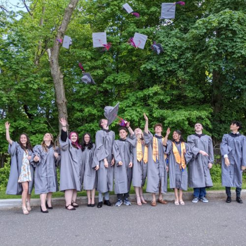 group of students throw their caps into the air