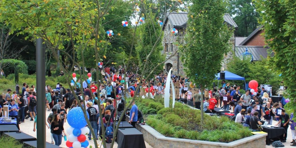 Campus walkway with lots of students.