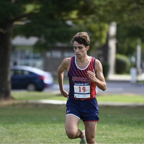 Jersey Blue male athlete running cross country meet