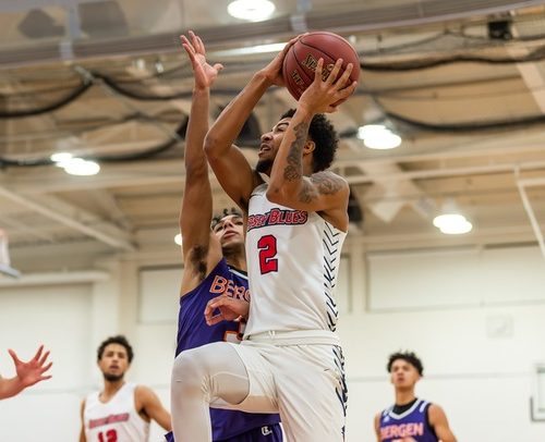 Man going up for a layup playing basketball