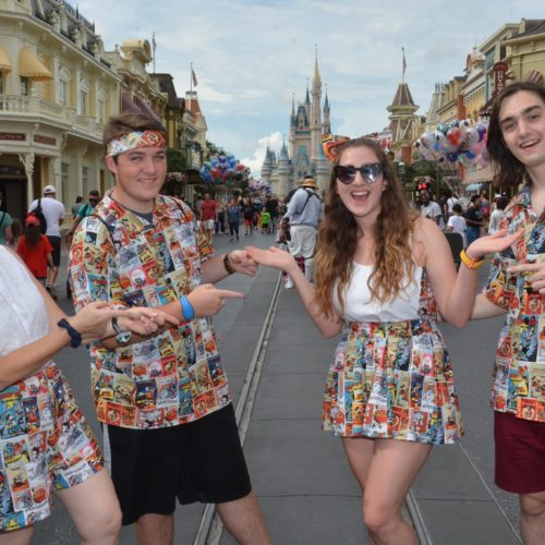 family of four two boys, a mother and a girl dressed in matching disney motif outfits