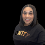 Woman with a smile on her face wearing a tee-shirt that says Unity