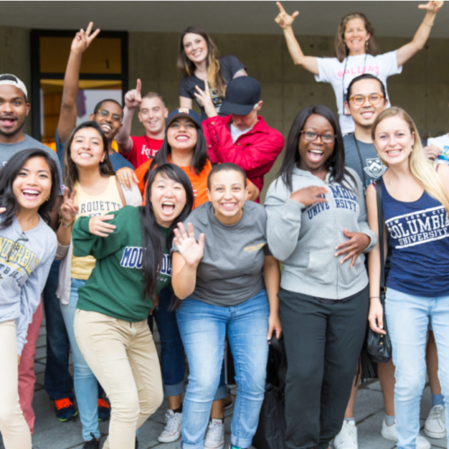 large group of students smiling and wearing college sweatshirts