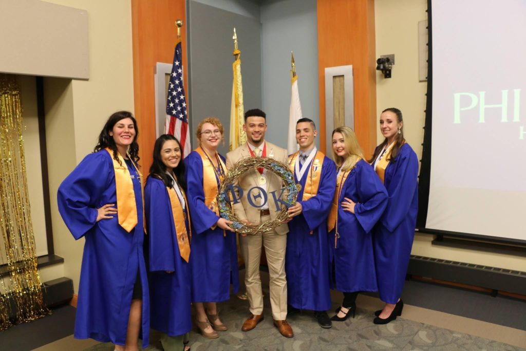 Picture of PTK Honors students in their graduation attire.
