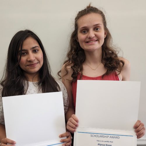Picture of Maria and Alyssa holding their scholarship certificates.