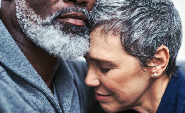 man and women embracing with compassionate faces