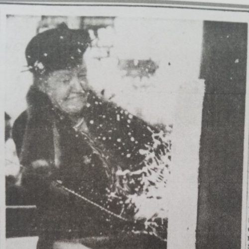 A newspaper article clipping of Mrs. Thompson smashing a champagne bottle against the ship