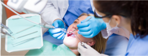 dentist working on female patient who has her mouth open