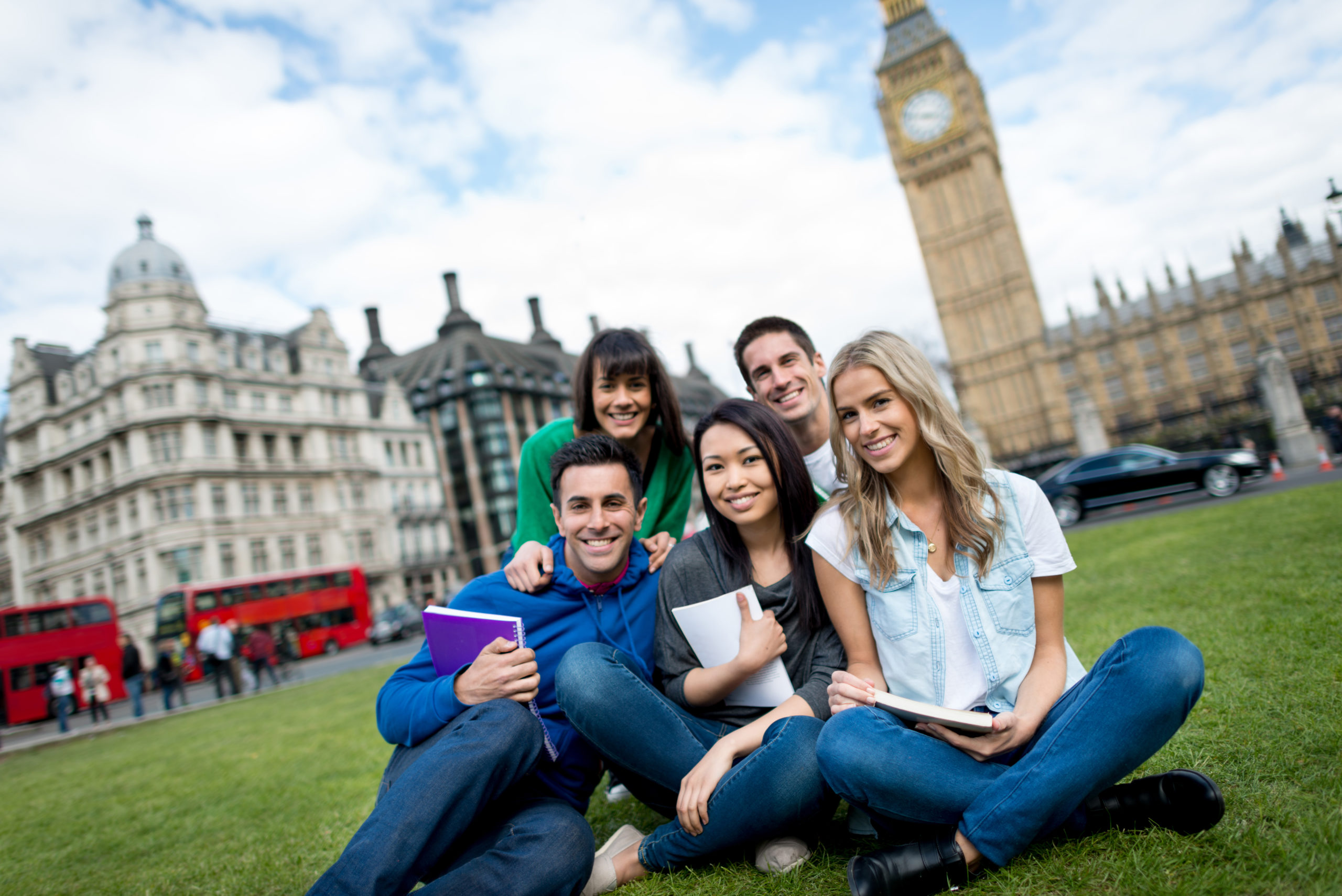Five students in front of clock in London