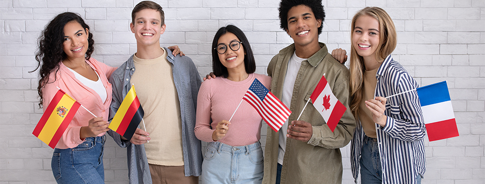 Group of diverse students holding their home flags.