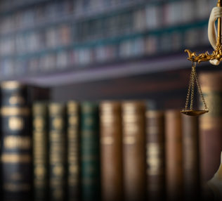 Picture of the a miniature statue of the scales of justice.
