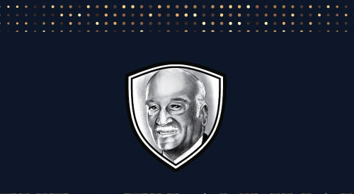 Black background with gold letters and a black and white face of Wilbur Ray that is in a shield.