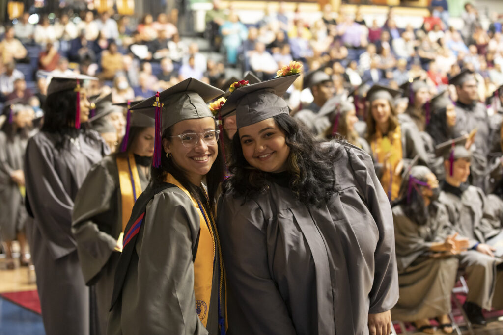 Picture of 2 graduates at graduation.