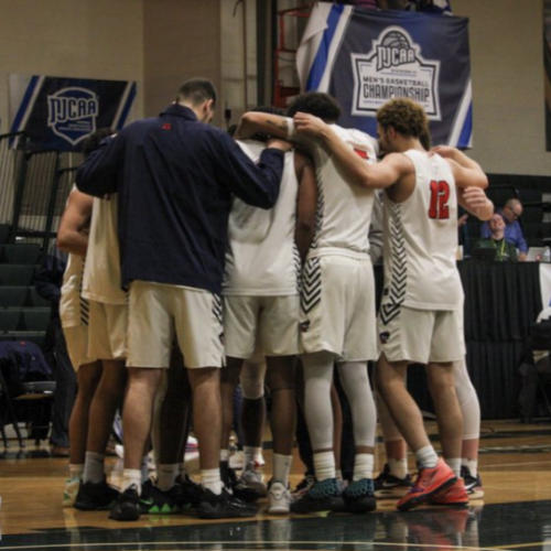 Men's basketball team in a huddle