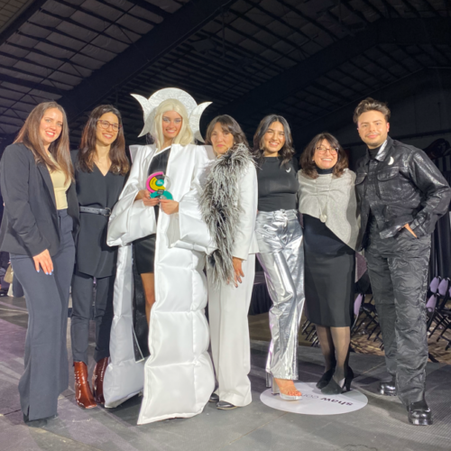 IIDA 2023 Team on the runway with award and model.