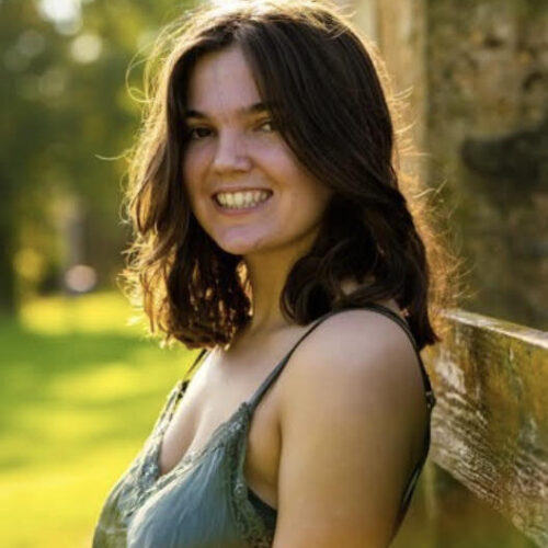 Woman with dark hair smiling.