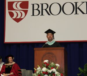 Sean P. O'Halloran at podium wearing cap and gown.