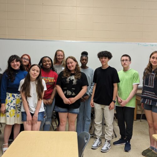 A group of 10 diverse students in a classroom.