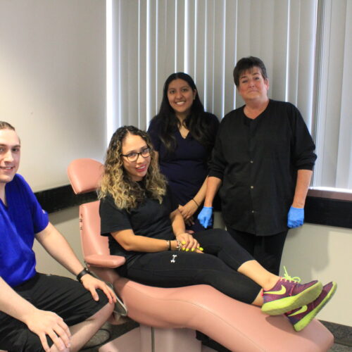 3 dental students and the instructor in the mock dental office.