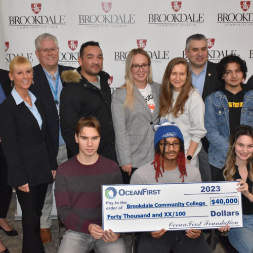 Group of students and members of OceanFirst Bank and Foundation and Brookdale Community College President and Vice President. Students are holding a check for $40,000 from OceanFirst Foundation.