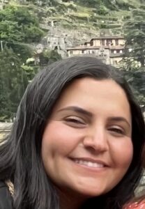 Woman with dark brown hair wearing a smile.