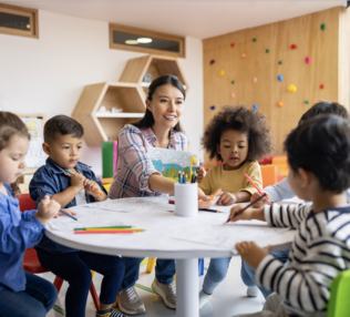 PreK-3 Teacher at table with 5 students