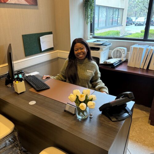 Natalie Jones sitting at her desk at the Radisson Hotel.