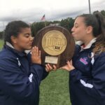 Brianna Quezada with team trophy at Brookdale Community College