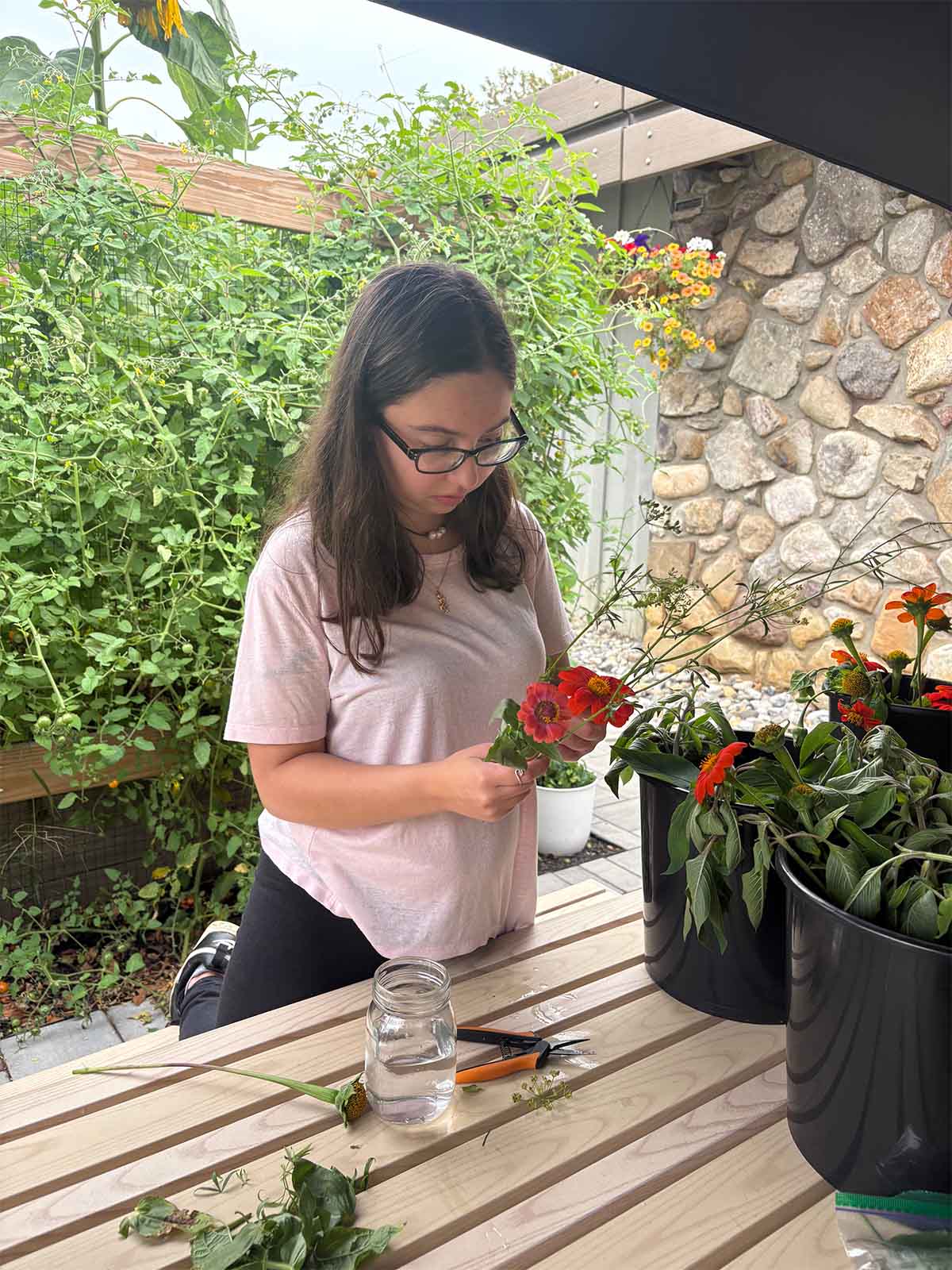 Student prepares flowers to be placed in a vase.