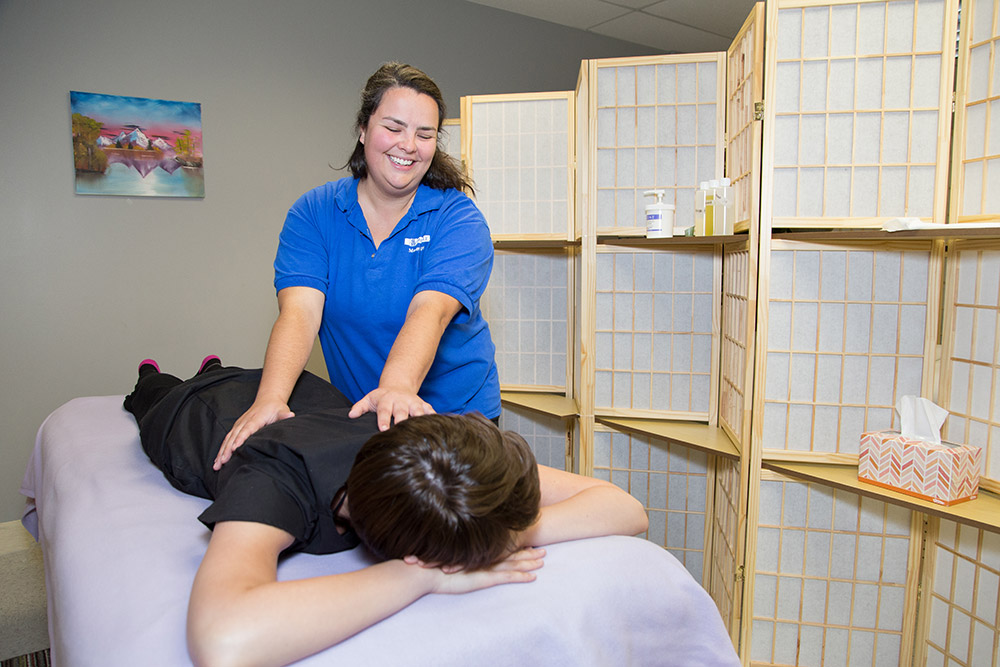 a Massage Therapy student working on a client